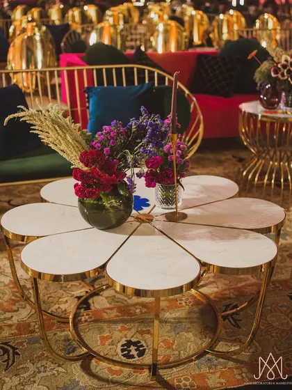 I designed this unique flower-shaped center table to be a conversation starter, topped with simple yet elegant floral arrangements.