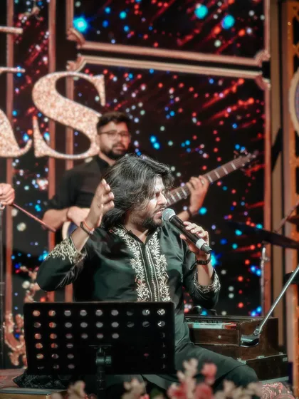 This image shows the full band setup with our lead singer at the forefront, against a dynamic LED background, blending traditional performance with modern stagecraft.