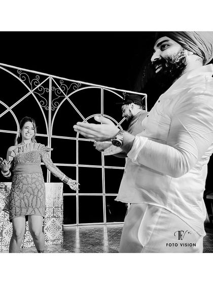 A candid black and white shot from the dance floor. We capture the fun and energy of the guests and the couple as they celebrate together.