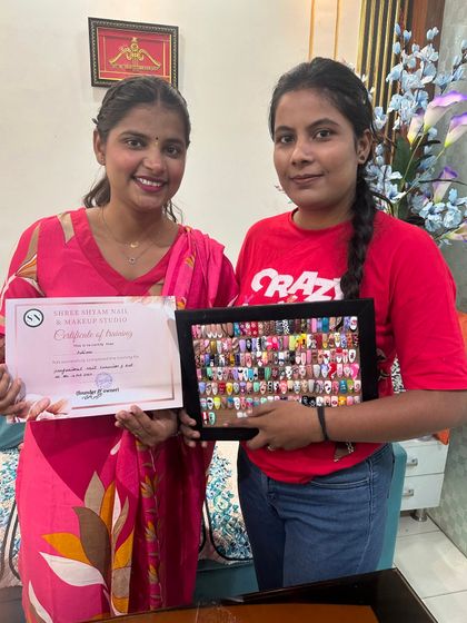 Presenting a new graduate with her certificate and her stunning collection of practice nail art. A new batch is starting soon.