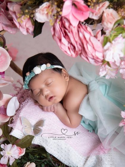 A circle of love and flowers. This beautiful floral wreath perfectly frames the sleeping baby, creating a portrait that is full of harmony and peace.