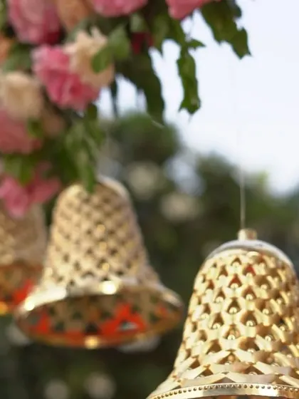 These intricate, latticed brass bells are a versatile decorative element I love to use. Hung from floral arrangements or as part of a larger installation, they add a traditional charm and a sense of sacred sound to the atmosphere.
