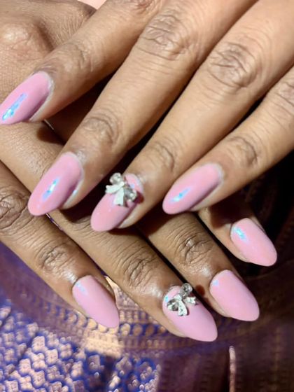 This set features a lovely pink gel polish with a subtle chrome effect, giving it a pearly sheen. To make it extra special, I added 3D silver bow charms on the accent nails.