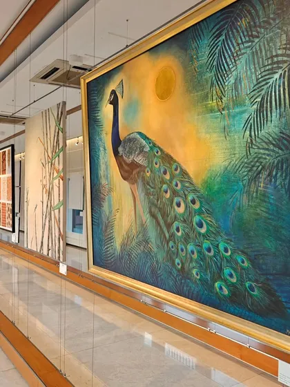 The majestic peacock, a centerpiece from the 'Nature's Symphony' exhibition. This large-scale painting showcases the incredible detail and vibrant color that define the high-caliber art we curate.