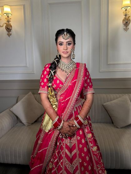 A full-length shot capturing the elegance and grace of our Sikhni bride in her beautiful pink lehenga and our exquisite jewellery.