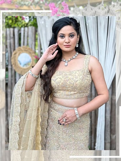 A close-up of the model in the beige lehenga, showing the detailed embroidery on the blouse.