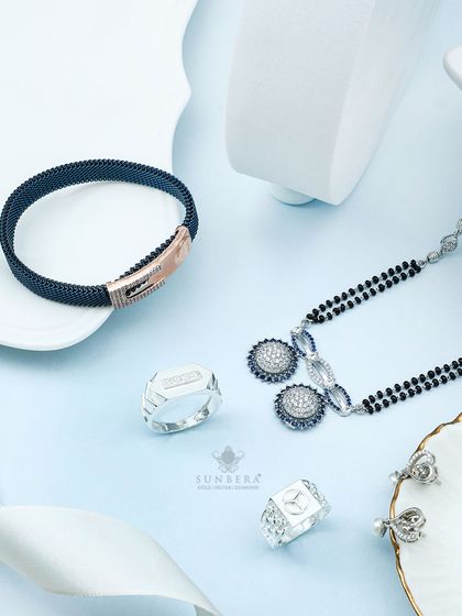 This collection highlights our men's and women's silver jewellery. It features a mesh bracelet, statement rings, and a modern mangalsutra, showcasing pieces crafted to perfection.