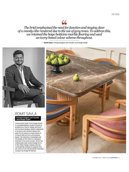 My portrait alongside the dining area in the Good Homes Magazine feature, where I explain the color and material choices.