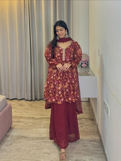 This maroon peplum-style sharara set is a trendy and stylish option for a modern festive look. The floral print adds a touch of softness to the rich color.