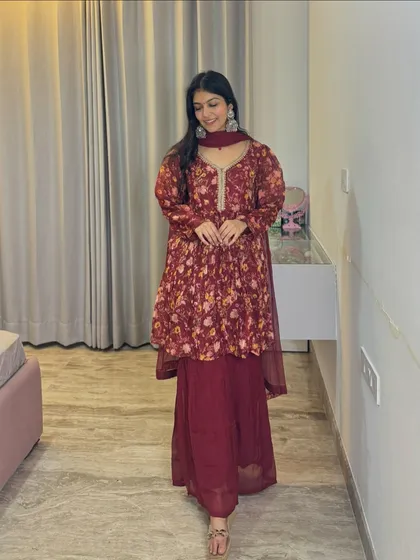 This maroon peplum-style sharara set is a trendy and stylish option for a modern festive look. The floral print adds a touch of softness to the rich color.