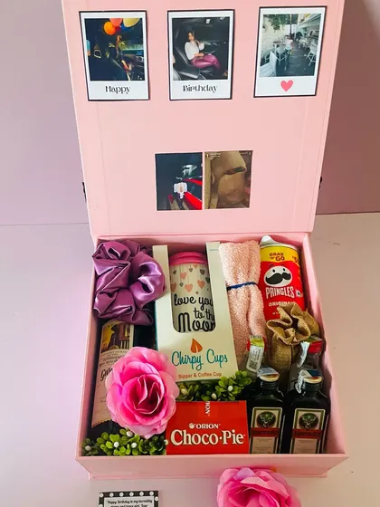 A large pink hamper box created for a girlfriend's birthday. The lid is decorated with polaroid-style photos for a personal touch.