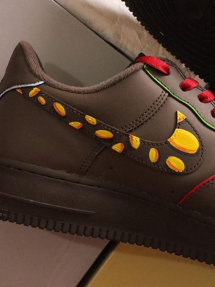 A detail shot of the swoosh on the Scrooge McDuck AF1s, which I turned into a trail of gold coins. It's a creative way to integrate the theme into the shoe's original design.