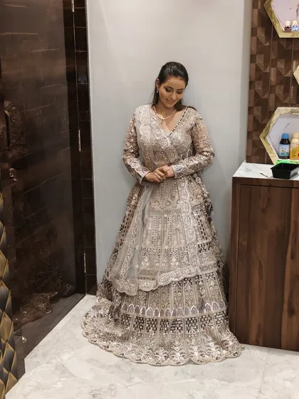 A client posing in a heavily embroidered grey and silver lehenga. A stunning choice for a reception.