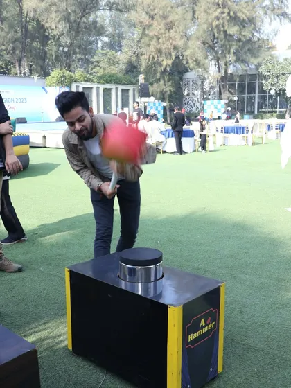 A guest in mid-swing at the hammer game, showing the dynamic action this rental brings to an event.