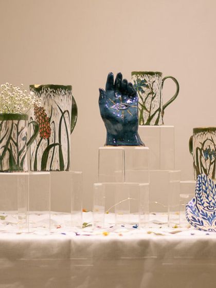 Another angle of the beautifully arranged display at GLAZED '22, showcasing a variety of student work.