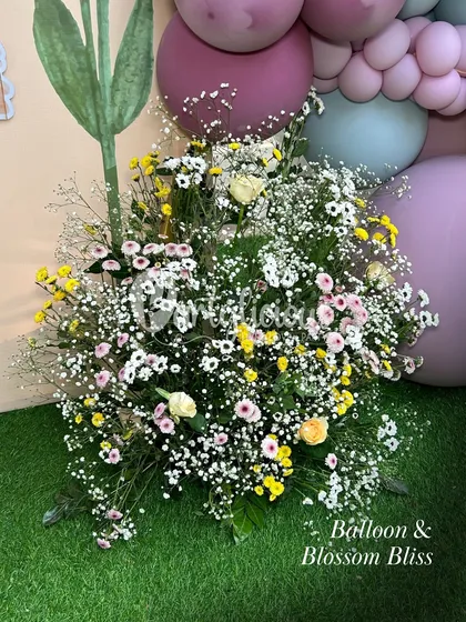 Balloon and blossom bliss. A gorgeous floral arrangement in soft pastel colors, perfect for a baby shower centerpiece.