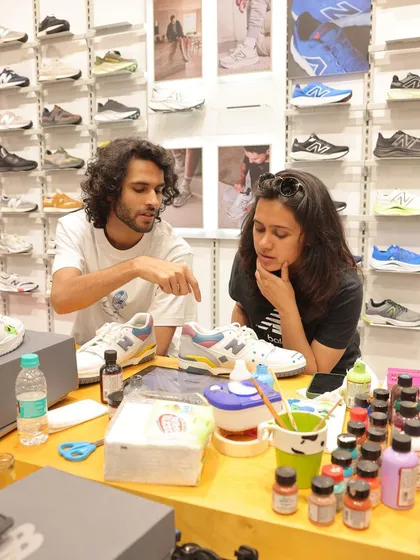 A big part of live art is the conversation. Here I am at the New Balance event, brainstorming ideas with a customer for his custom sneaker design. We work together to make sure the final piece is exactly what he envisions.