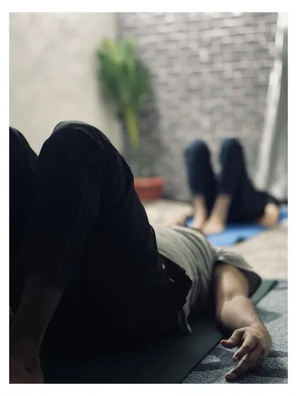 A moment of relaxation and gentle stretching during a morning flow class. These quiet moments are just as important as the challenging poses.