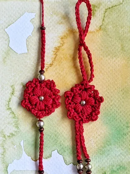 This beautiful red floral rakhi and lumba set is another one of our special designs for Rakshabandhan. The intricate flower design is accented with silver and wooden beads.