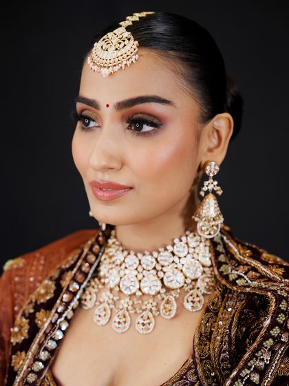 This three-quarter view shows how the contour and highlight sculpt the face for photography. You will learn camera-ready makeup techniques as part of the curriculum.