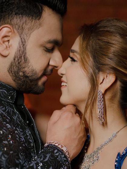 A close-up portrait capturing the intimate and playful connection between the couple. Their genuine smiles and closeness make this a heartwarming example of our candid couple photography.