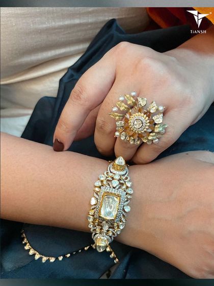 A perfect festive pairing. This photo shows a statement floral polki ring and a heavy polki bracelet worn together, showcasing the rich traditions of our craft.
