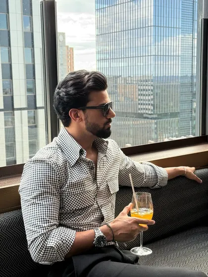 Our 2KW check black and white shirt, a versatile piece for the modern man. Here it is styled for a sophisticated drink at a rooftop bar.
