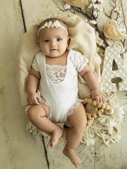 A classic baby portrait. This little one, holding her initial, looks so sweet and content in her cozy basket.