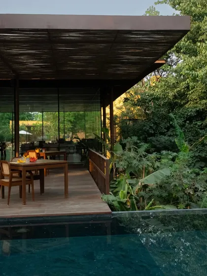 The view from the pavilion deck, looking across the pool to the dense forest, an escape in the heart of Delhi.