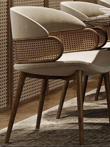 I pay close attention to detail, like in this bespoke dining chair. It combines a modern upholstered seat with a beautifully curved, hand-woven rattan backrest, all supported by a sturdy, elegant teak wood frame for a light, airy feel.