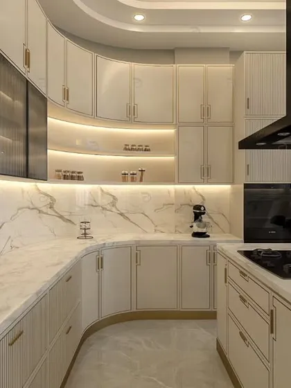 A kitchen designed for those who love to cook. We conceptualized this space with a sweeping curved counter, marble-patterned backsplash, and a neutral color theme, enhanced by integrated lighting and gold PU grooving for a truly luxurious feel.