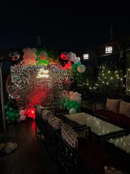 A closer look at the birthday backdrop with the number '2' foil balloon.