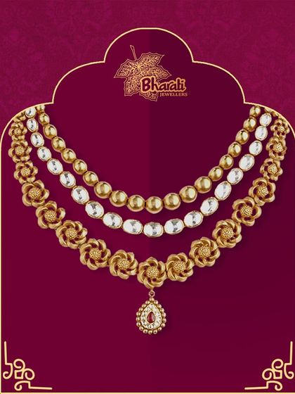 A stunning three-layered oxidized necklace designed to elegantly fill the neckline. Each layer features a unique pattern, from polished beads to uncut stones and floral motifs, creating a rich and textured look.