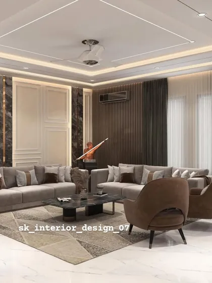 A spacious living room with a large sectional sofa and a feature wall with dark marble and wood paneling. The design is perfect for large families and for hosting gatherings.