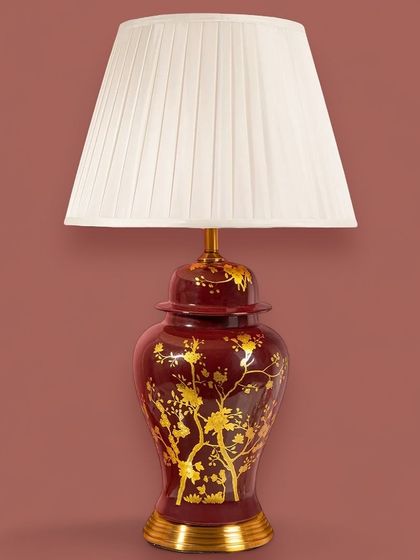 This rich, crimson-red lamp with gold chinoiserie-style branches makes a bold and dramatic statement. It's perfect for adding a touch of opulence and warmth to a formal living room or study.