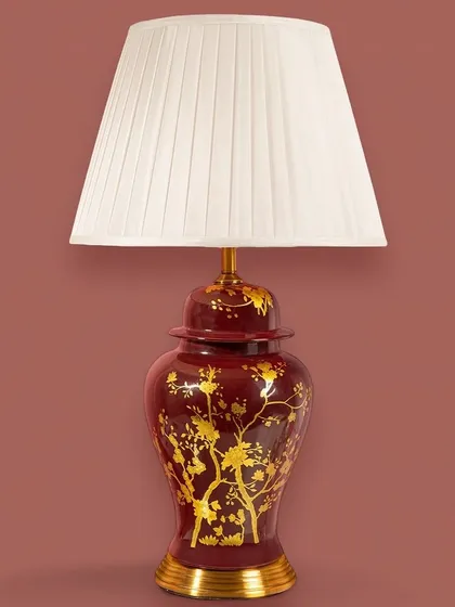 This rich, crimson-red lamp with gold chinoiserie-style branches makes a bold and dramatic statement. It's perfect for adding a touch of opulence and warmth to a formal living room or study.