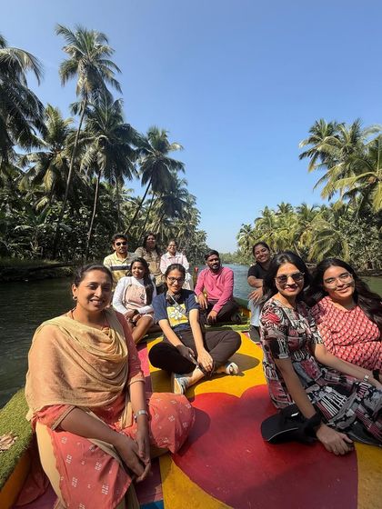 A lovely group photo on the colorful boat during the Honnavar backwater tour.