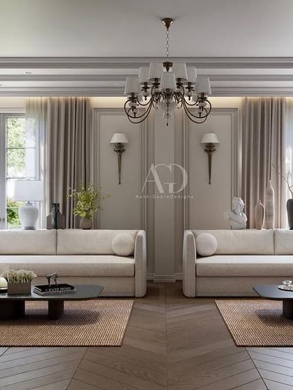 This living room design emphasizes warm tones and varied textures. The symmetrical arrangement of sofas creates a formal conversation area, while the herringbone wood floor adds a classic, durable foundation.