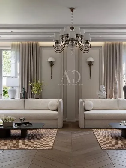 This living room design emphasizes warm tones and varied textures. The symmetrical arrangement of sofas creates a formal conversation area, while the herringbone wood floor adds a classic, durable foundation.