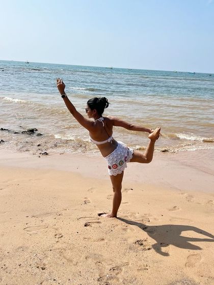 Inhale courage, exhale fear. A beautiful Natarajasana (Dancer's Pose) on the beach in Goa, feeling the sun, sea, and sand.
