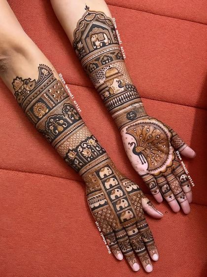 A unique design with a large peacock on one palm and a pattern of small elephants on the other.