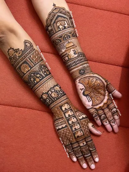 A unique design with a large peacock on one palm and a pattern of small elephants on the other.