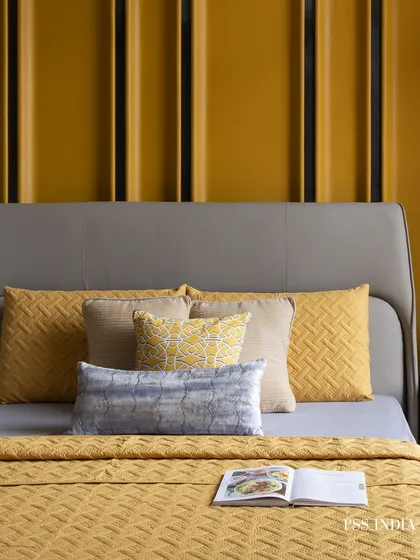 A great example of how to use a bold color effectively. The vibrant yellow paneled wall and matching bedding create a cheerful and energetic atmosphere, balanced by the cool grey of the modern headboard.