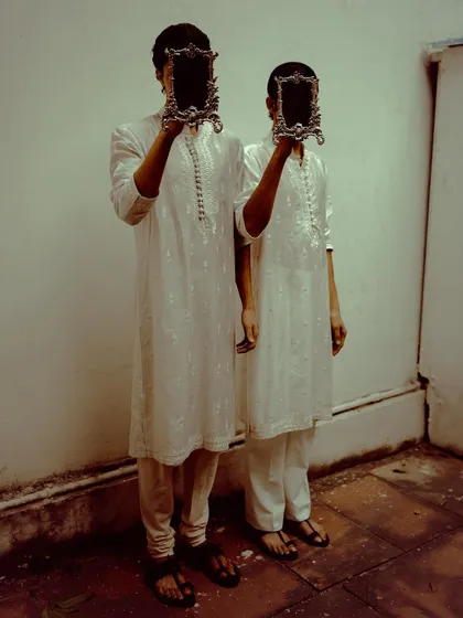 A conceptual shot for designer Sanchit Sharma, where models hold ornate mirrors obscuring their faces. This image plays with ideas of identity and reflection, creating a surreal and thought-provoking fashion narrative.