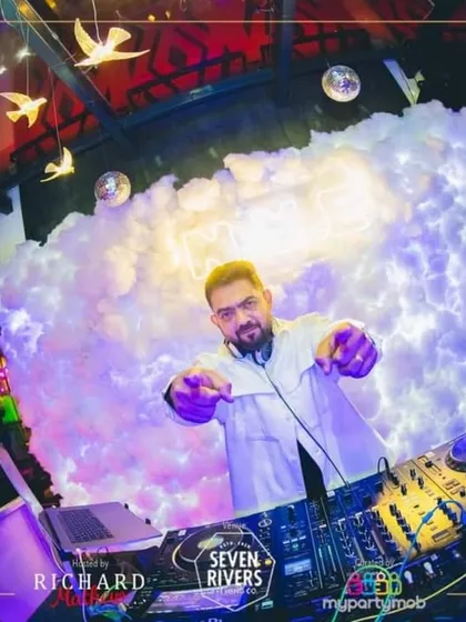 In my element at Seven Rivers, Taj MG Road. A great DJ set is about connecting with the crowd, and this shot captures that interaction. I'm not just behind the decks; I'm part of the party.
