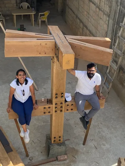 Team members perched on a completed timber column mockup at the House of Galleries. Site visits are a time for both serious work and team camaraderie.
