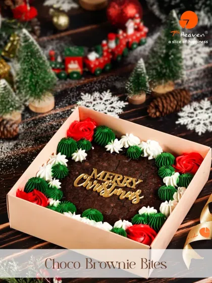 Bite into Christmas with our Choco Brownie Bites. This shareable box features a large brownie decorated with festive red and green frosting and a "Merry Christmas" plaque.