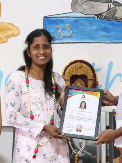 A student receives her Aerial Yoga Teacher Training certificate from me. It is a joy to see students master new skills and grow in confidence.