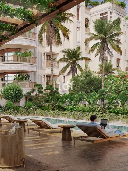 This view of 'Casa Paraiso' shows the idyllic retreat we designed to capture the serene charm of tropical elegance. The poolside deck, surrounded by lush greenery and framed by the building's classical facade, offers the perfect escape.