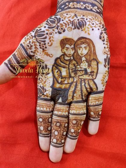 A detailed look at a palm with a portrait of a couple holding their newborn baby. This style of figure work is my specialty and adds a deeply personal touch to your baby shower mehendi.